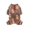 Dog wearing soft coffee-colored flannel pajamas with cartoon bear and dinosaur print.

