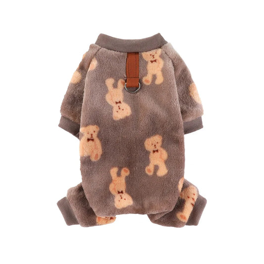 Dog wearing soft coffee-colored flannel pajamas with cartoon bear and dinosaur print.

