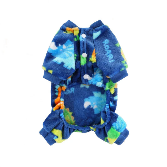 Dog wearing blue flannel pajamas with cartoon bear and dinosaur print for winter.

